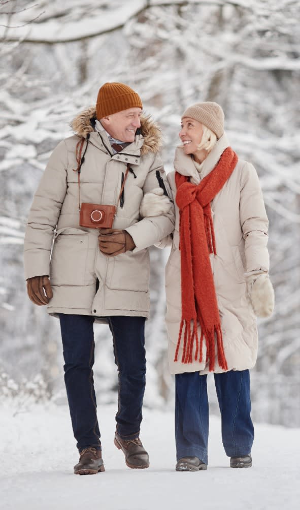 Elderly couple walking in the snow